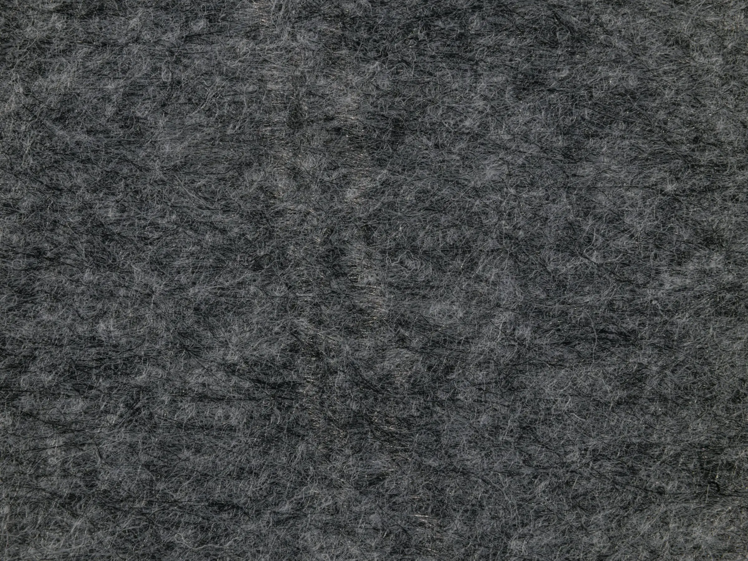 Textura de fieltro de lana gris, vista muy de cerca.
